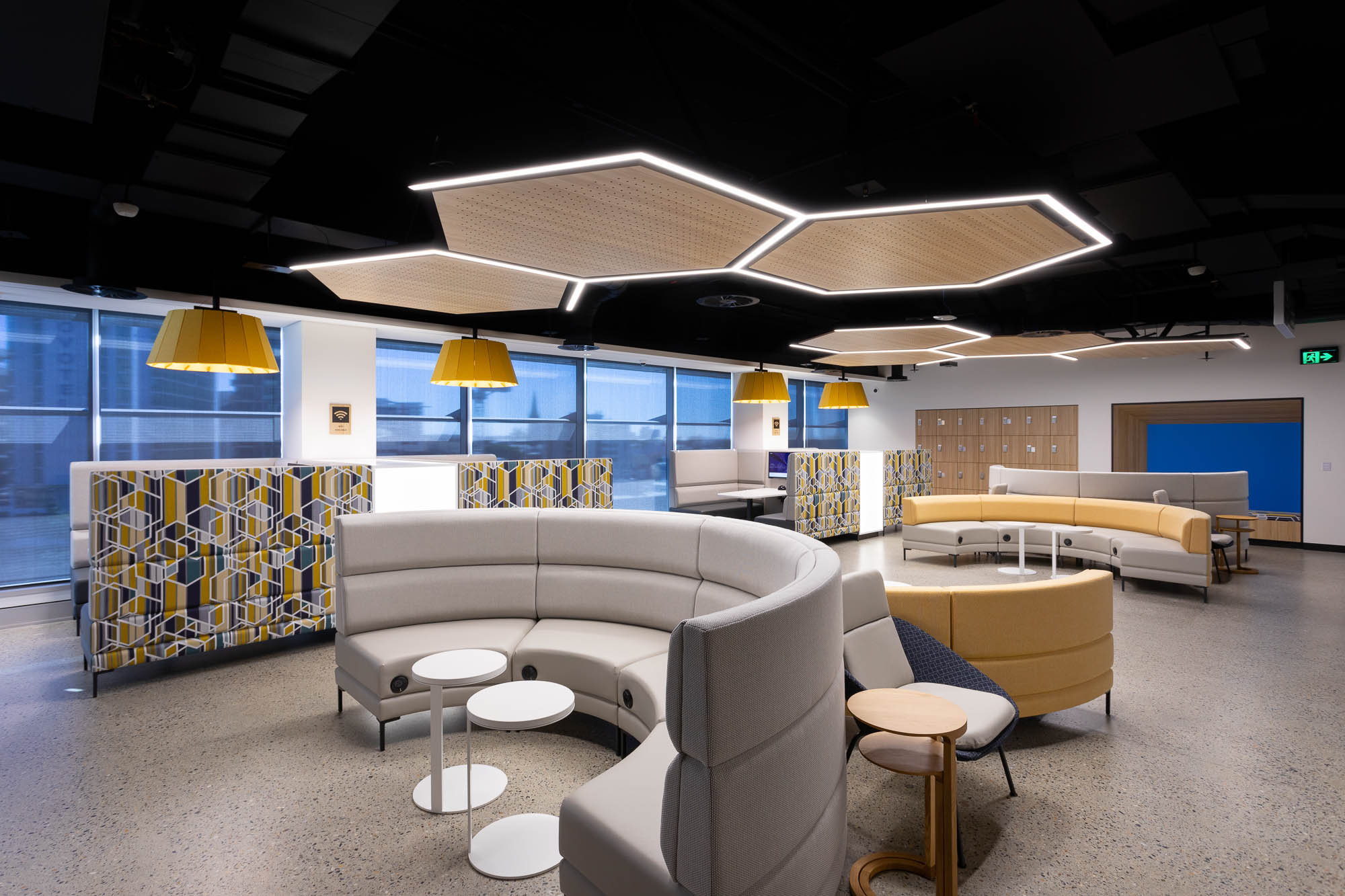 Federation University breakout area with hexagon bulkhead, and curved schiavello furniture